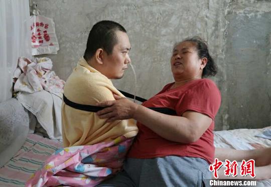 身體日漸衰老的梁青蘭每次幫兒子翻身、坐立，全身的衣物都要濕透一次?！∩忻鱾b 攝